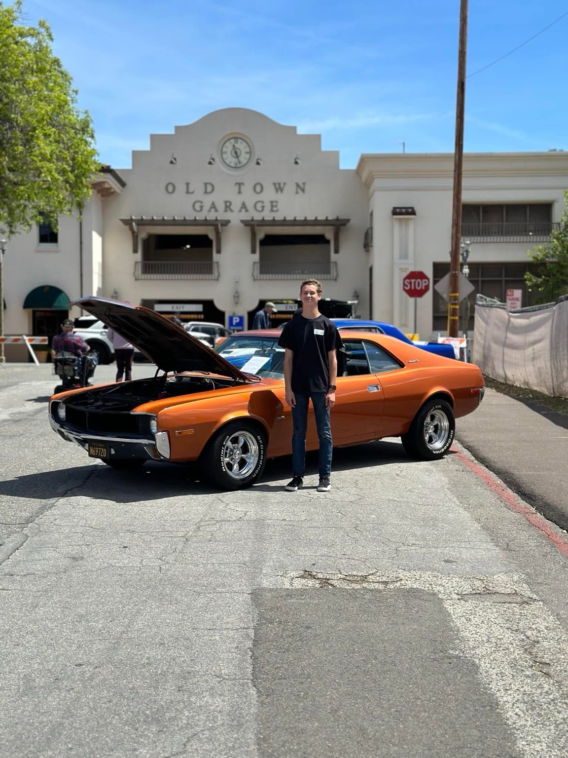 Hemi standing beside his copper-colored 1970 AMC Javelin with the hood open.
